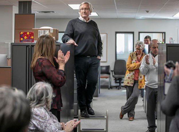 New Mexican Publisher Tom Cross, on stool, announces his retirement Wednesday during a staff meeting at the newspaper's downtown offices. At right are New Mexican Editor Phil Casaus and owner Robin Martin. (Jim Weber / The New Mexican)